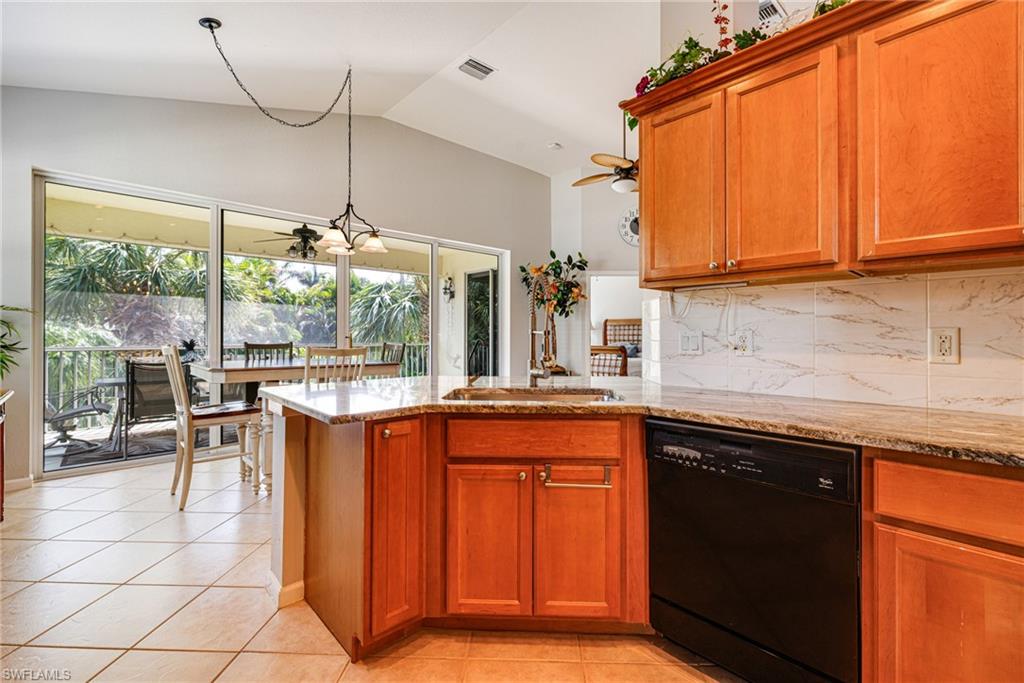 19081 Ridgepoint Drive, Unit 201 Estero, FL 33928 - Photo 12 of 42 a kitchen with stainless steel appliances granite countertop a sink and a counter space