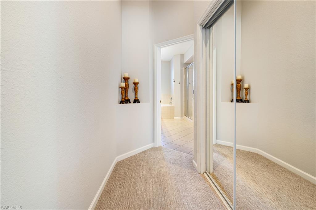 19081 Ridgepoint Drive, Unit 201 Estero, FL 33928 - Photo 14 of 42 a view of a hallway with wooden floor and closet