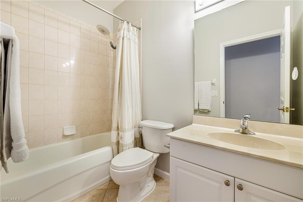 19081 Ridgepoint Drive, Unit 201 Estero, FL 33928 - Photo 19 of 42 a bathroom with a sink a toilet and a mirror