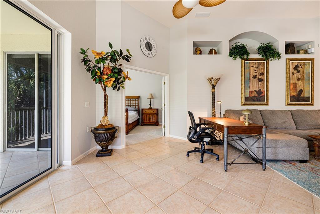 19081 Ridgepoint Drive, Unit 201 Estero, FL 33928 - Photo 24 of 42 a living room with furniture and a potted plant