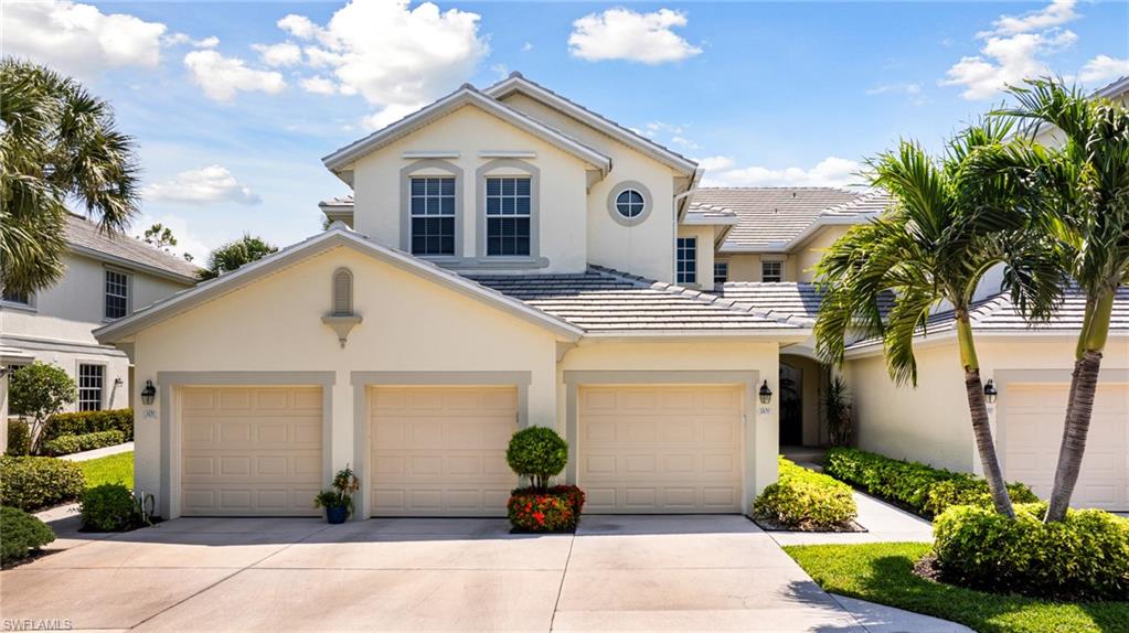 19081 Ridgepoint Drive, Unit 201 Estero, FL 33928 - Photo 30 of 42 a view of a white house with a yard and potted plants