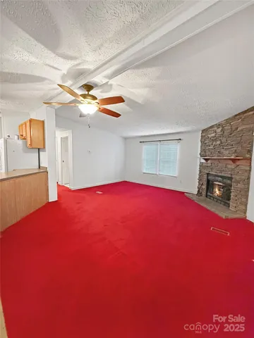 a view of empty room with window and fireplace