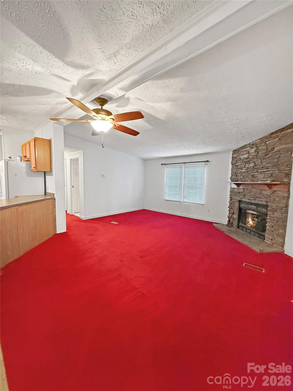 121 Haystack Lane Olin, NC 28660 - Photo 12 of 23 a view of empty room with window and fireplace