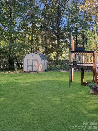 a view of a house with backyard and a tree