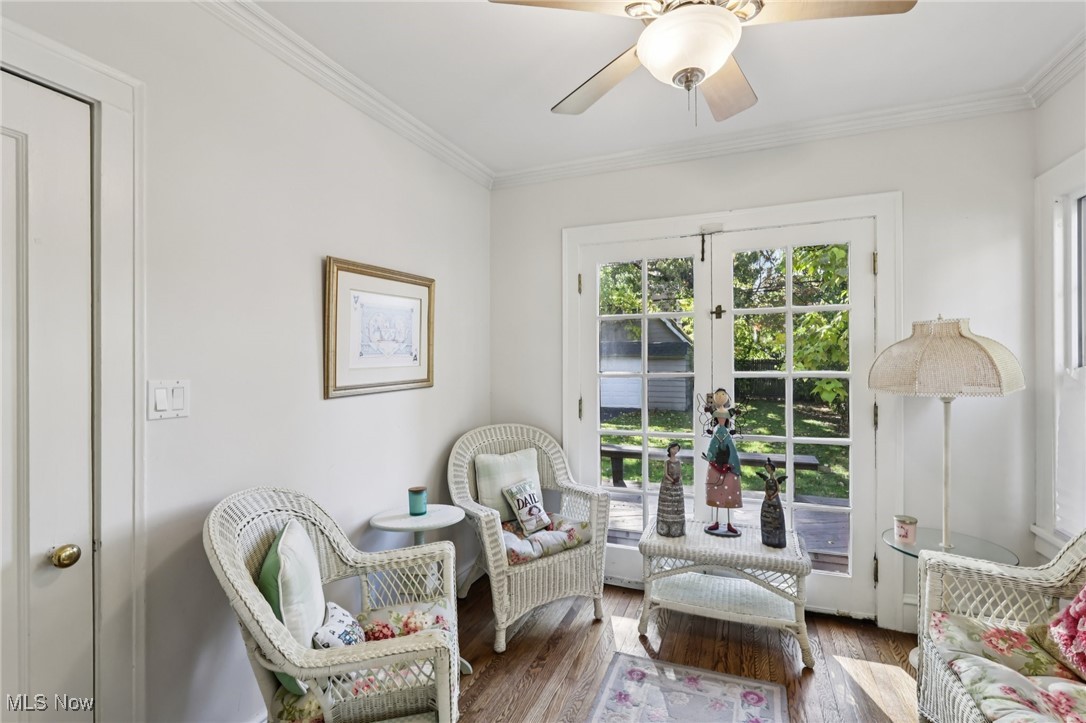 3054 East Overlook Road Cleveland, OH 44118 - Photo 15 of 50 Living area featuring wood finished floors, crown molding, a ceiling fan, and french doors