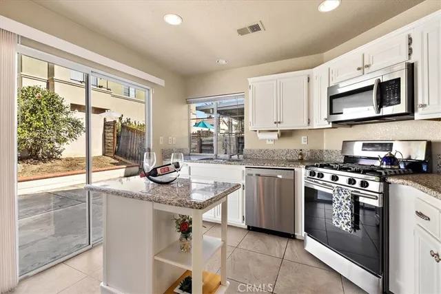 a kitchen with a stove a sink and a microwave