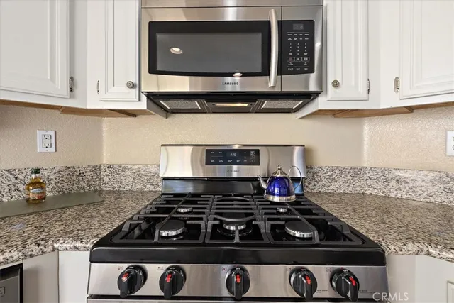 a stove top oven sitting inside of a kitchen