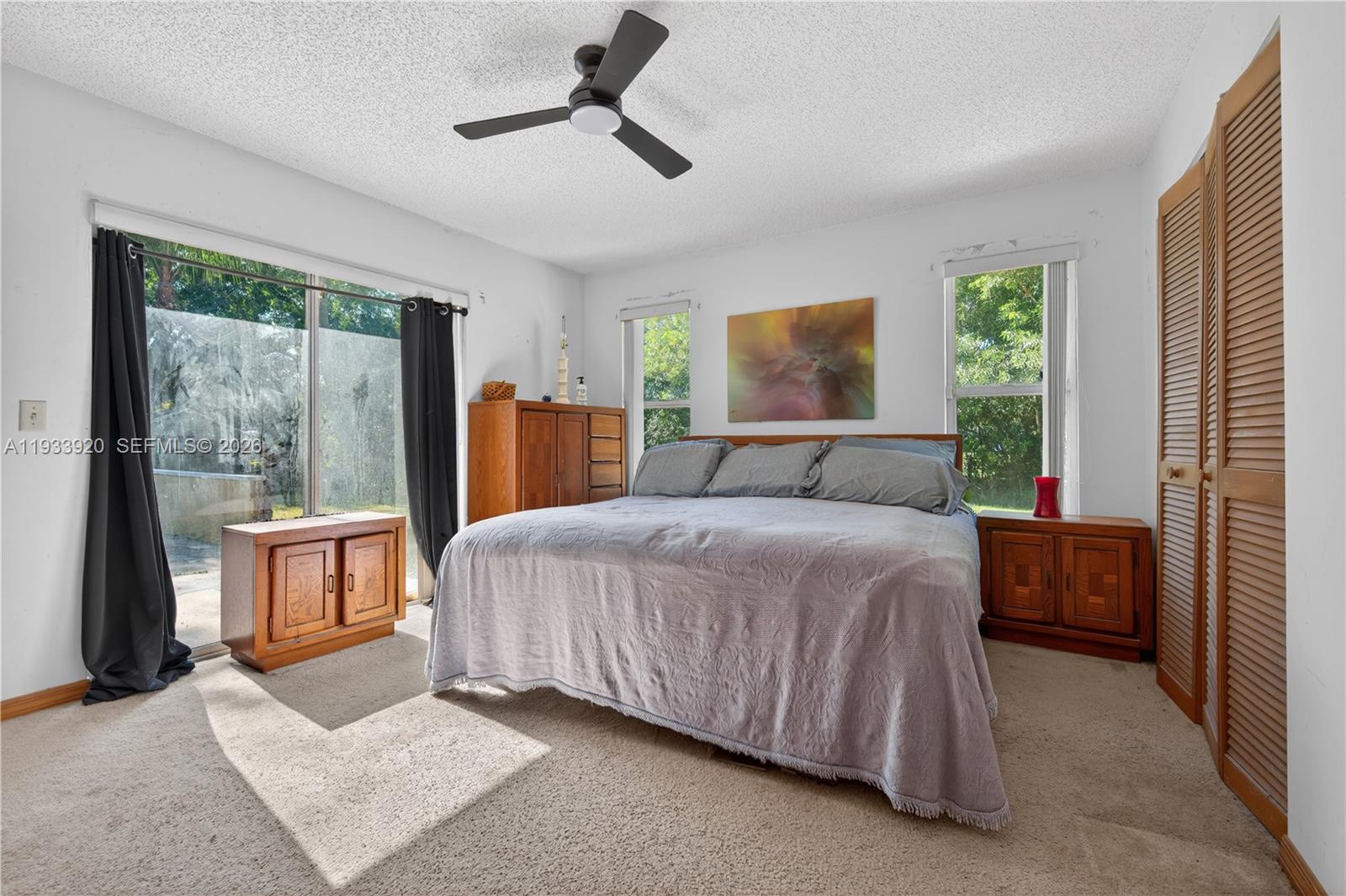 13228 158th Street North Jupiter, FL 33478 - Photo 11 of 21 a bedroom with a large bed and a large window