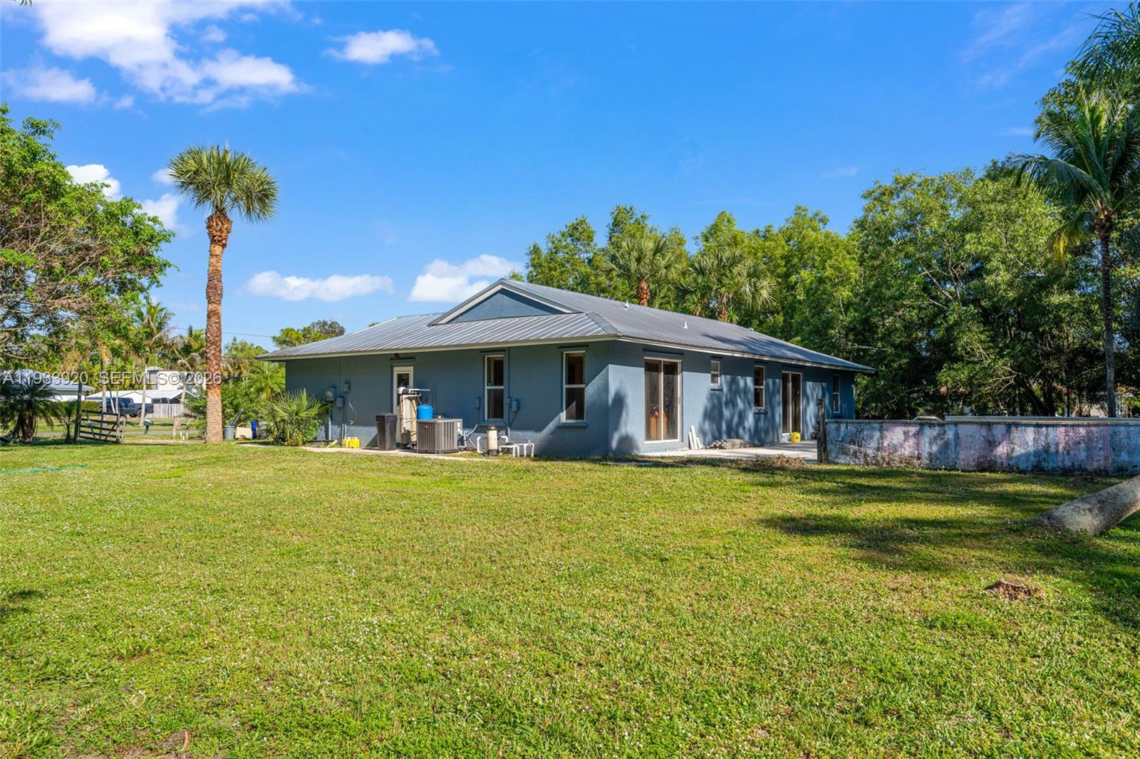 13228 158th Street North Jupiter, FL 33478 - Photo 19 of 21 a front view of a house with swimming pool having outdoor seating