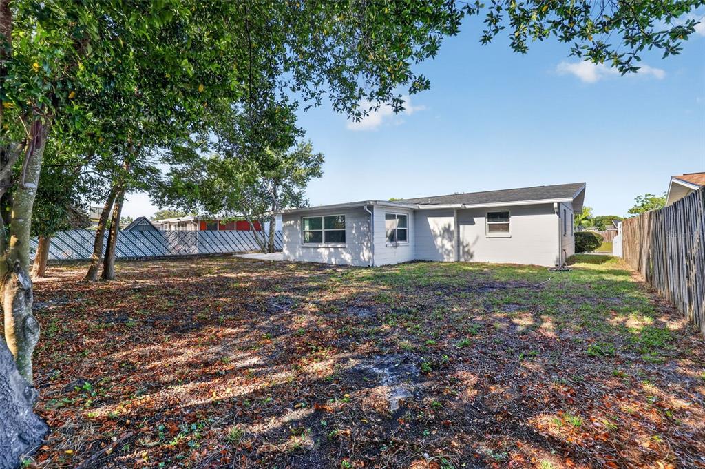 10914 Leeds Road Port Richey, FL 34668 - Photo 20 of 24 a view of a house with yard and a tree