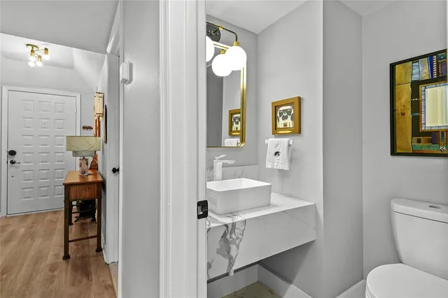 a bathroom with a sink toilet and mirror