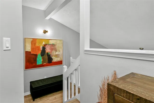 a view of a living room that has a stove and a painting on the wall