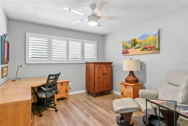 a living room with furniture a rug and a piano