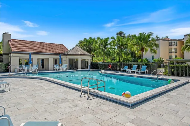 a view of house with swimming pool outdoor seating