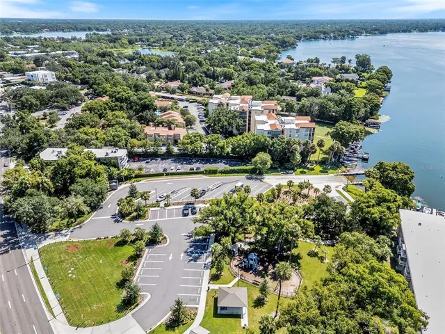 an aerial view of residential houses with outdoor space and trees