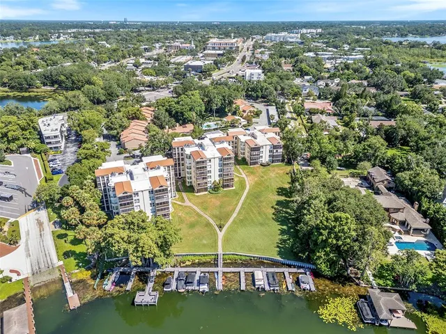 an aerial view of residential houses with outdoor space and swimming pool