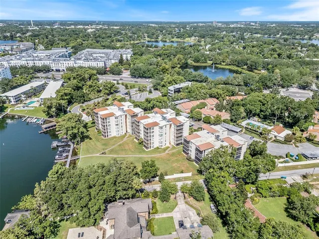 an aerial view of residential houses with outdoor space and trees
