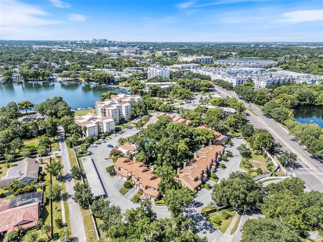 an aerial view of a city with lots of residential buildings lake and ocean view