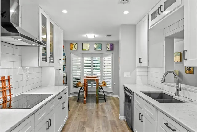 a kitchen with a sink stove and cabinets