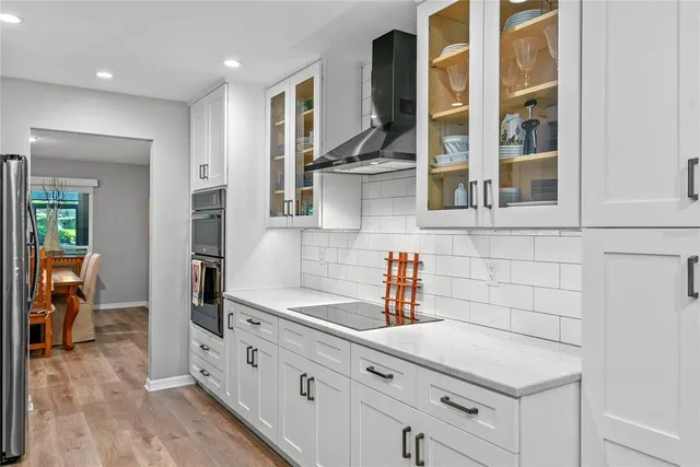 a kitchen with stainless steel appliances a sink stove and cabinets