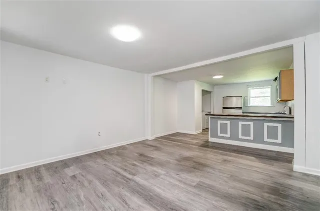 a view of kitchen and hall with wooden floor