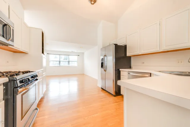 a kitchen with stainless steel appliances a refrigerator and a stove top oven