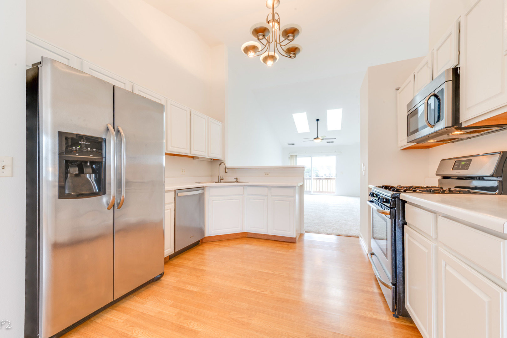 24181 Pear Tree Circle Plainfield, IL 60585 - Photo 7 of 25 a kitchen with stainless steel appliances a refrigerator and a stove top oven