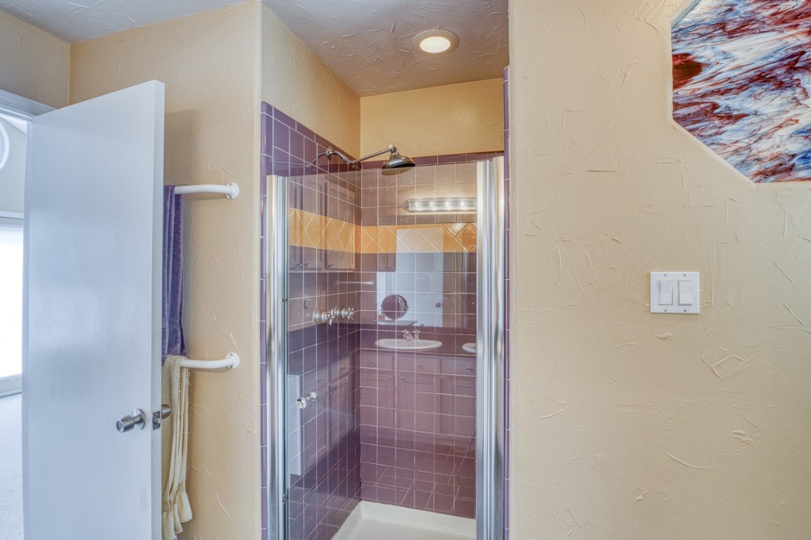 4804 Ranch Road 2222 Austin, TX 78731 - Photo 37 of 40 Bathroom with a textured wall, a stall shower, and a textured ceiling