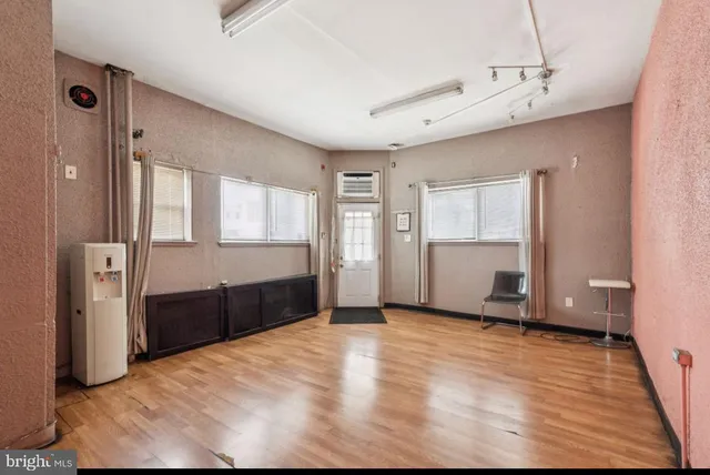 a view of empty room with wooden floor and cabinet