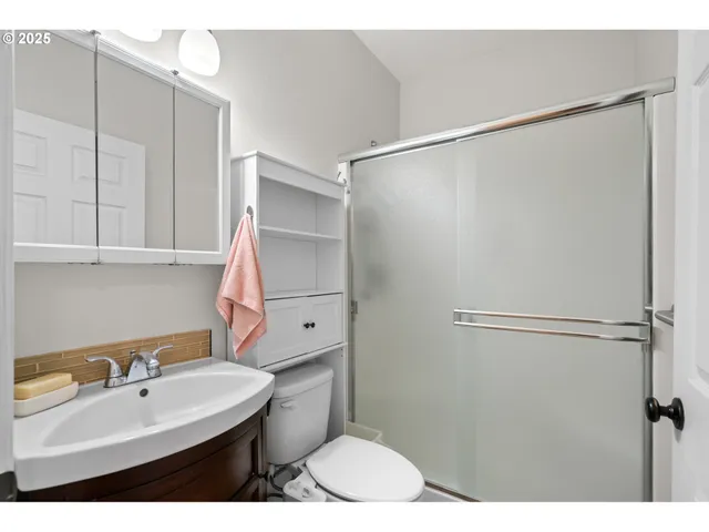 a view of an empty room with a chandelier fan