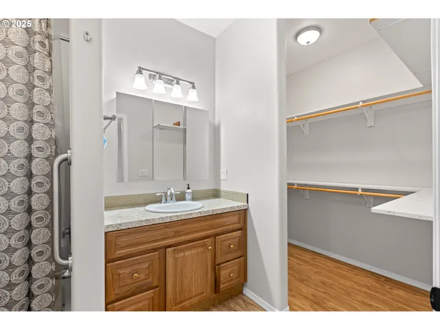 a bathroom with a granite countertop sink toilet a mirror and shower