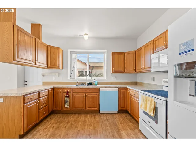 a kitchen with stainless steel appliances granite countertop a stove sink and cabinets
