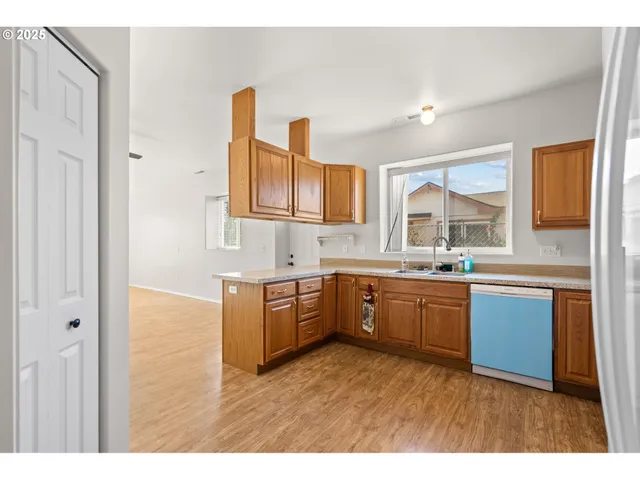 a kitchen with stainless steel appliances granite countertop a sink and cabinets