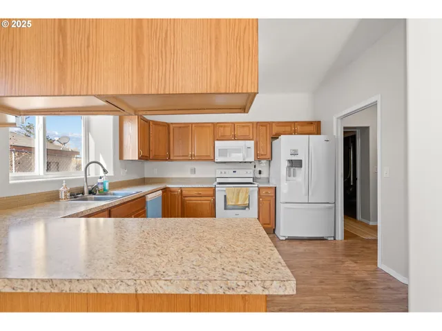 a kitchen with a refrigerator a sink and a stove
