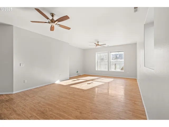 a view of a room with wooden floor and window