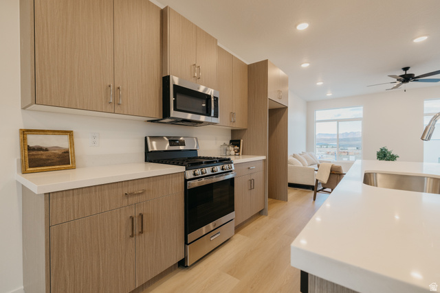 2759 Becco Trail, Unit 16 St. George, UT 84770 - Photo 12 of 42 Kitchen featuring stainless steel appliances, light wood-type flooring, recessed lighting, modern cabinets, and light stone countertops