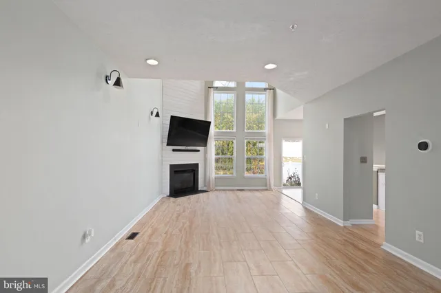a view of kitchen with microwave and refrigerator
