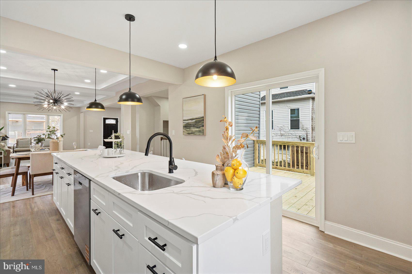 3925 Norfolk Avenue Baltimore, MD 21216 - Photo 15 of 49 a kitchen with stainless steel appliances granite countertop a sink a stove and a wooden floors