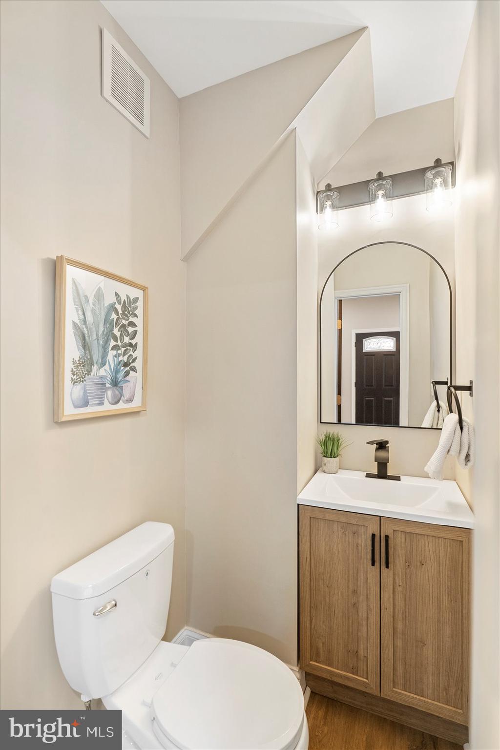 3925 Norfolk Avenue Baltimore, MD 21216 - Photo 20 of 49 a bathroom with a toilet sink and mirror