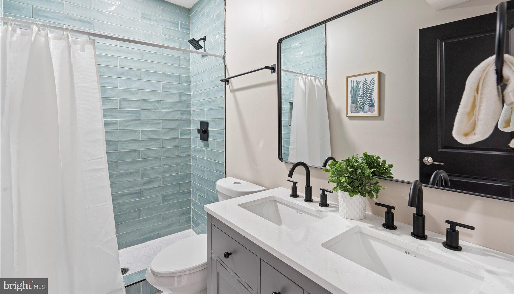 3925 Norfolk Avenue Baltimore, MD 21216 - Photo 24 of 49 a bathroom with a sink a toilet a mirror and shower