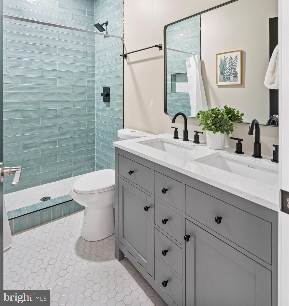 3925 Norfolk Avenue Baltimore, MD 21216 - Photo 26 of 49 a bathroom with a granite countertop sink a toilet and a mirror