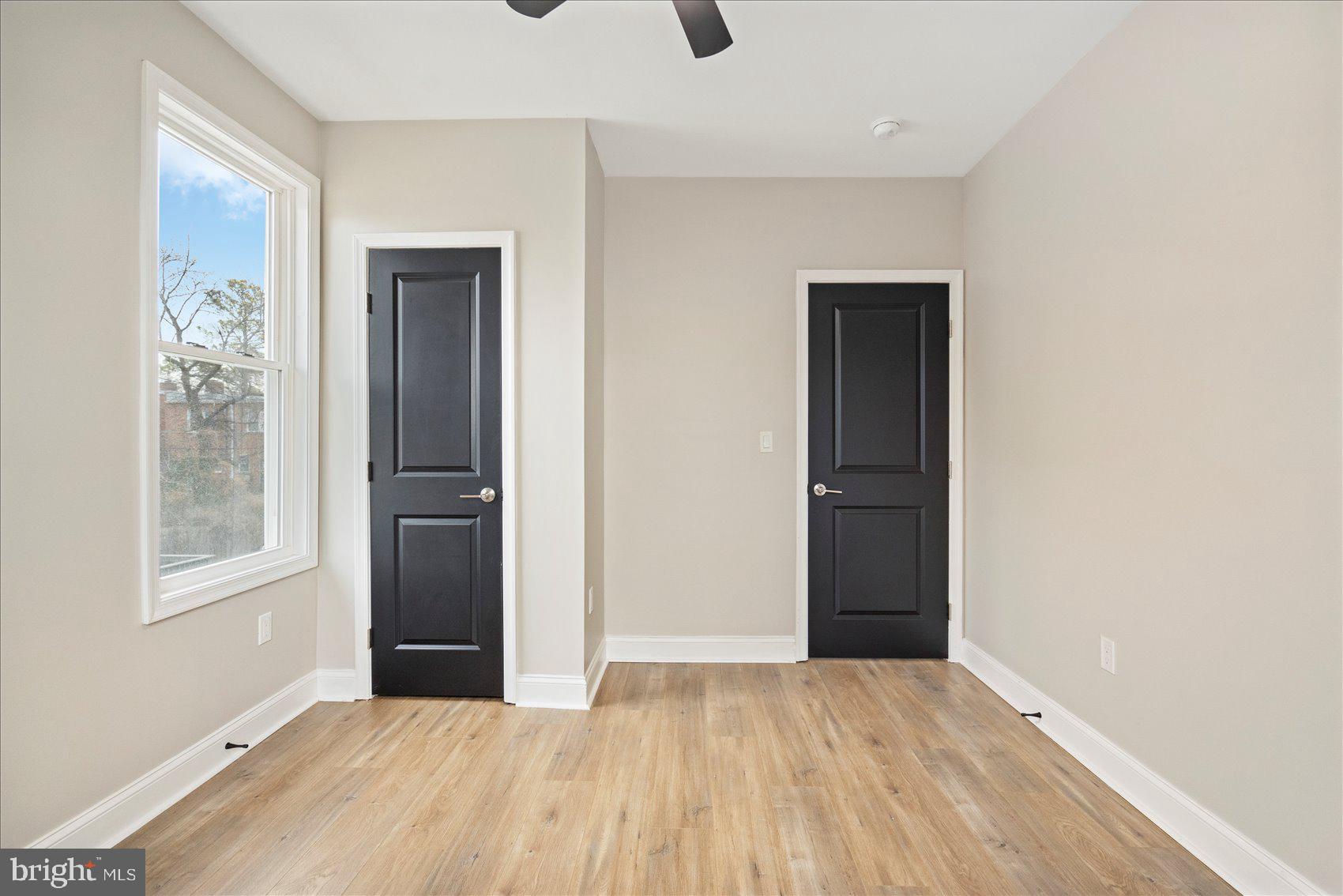 3925 Norfolk Avenue Baltimore, MD 21216 - Photo 36 of 49 a view of an empty room with wooden floor and a window