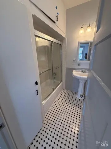 a bathroom with a sink toilet and shower