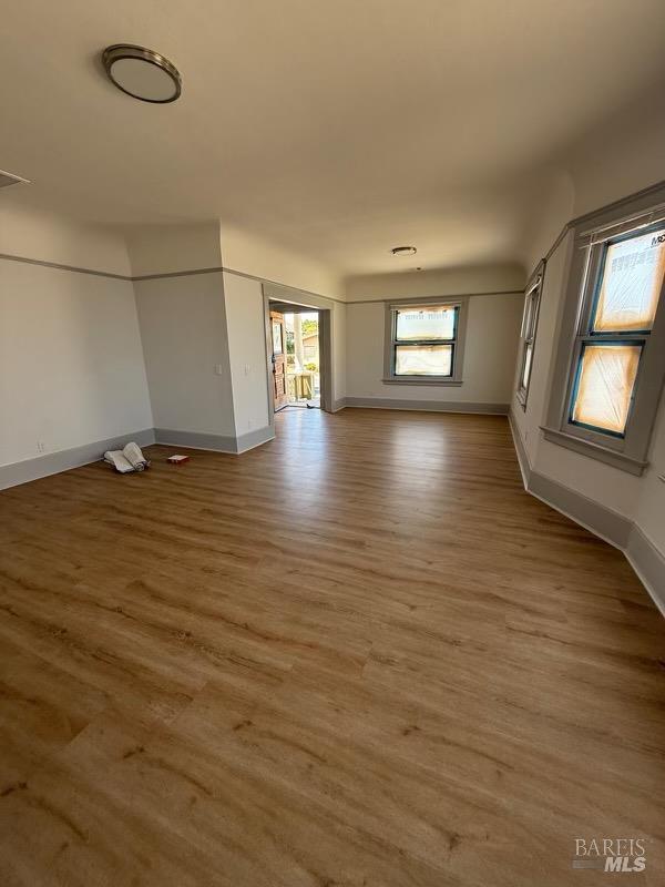 839 Capitol Street Vallejo, CA 94590 - Photo 7 of 8 an empty room with wooden floor and windows