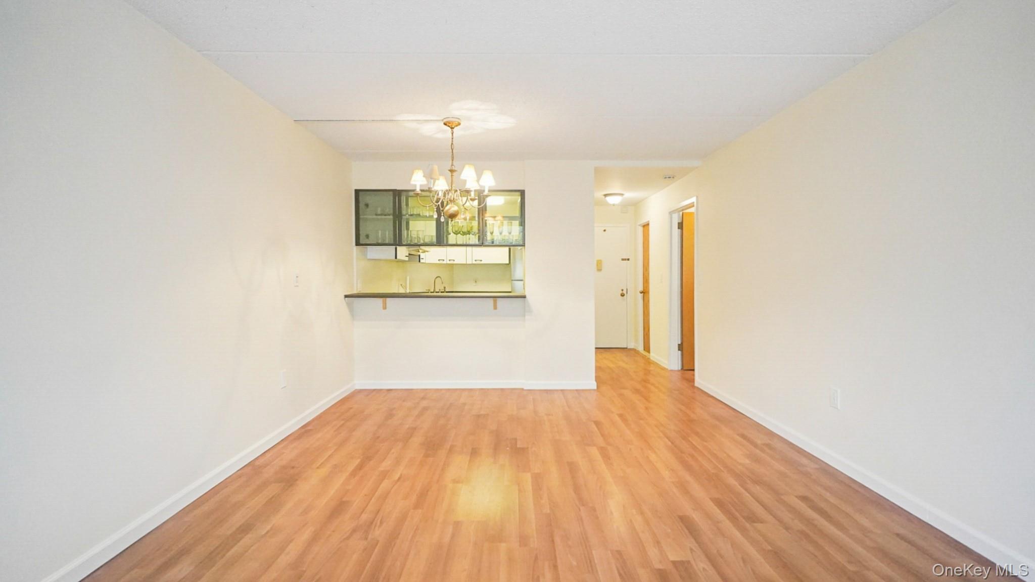 703 Pelham Road, Unit 107 New Rochelle, NY 10805 - Photo 5 of 14 a view of empty room with wooden floor