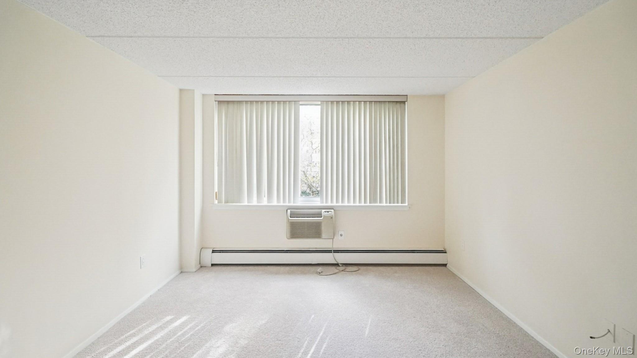 703 Pelham Road, Unit 107 New Rochelle, NY 10805 - Photo 7 of 14 a view of an empty room with a window