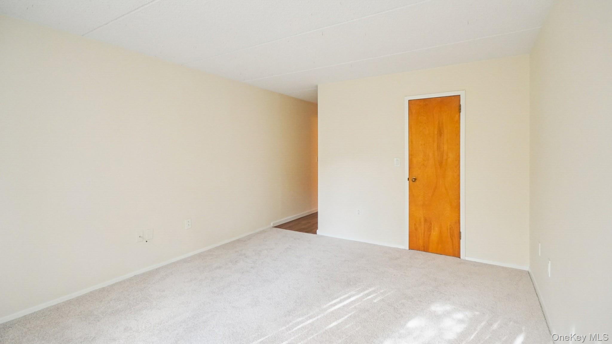 703 Pelham Road, Unit 107 New Rochelle, NY 10805 - Photo 8 of 14 a view of a room with a wall