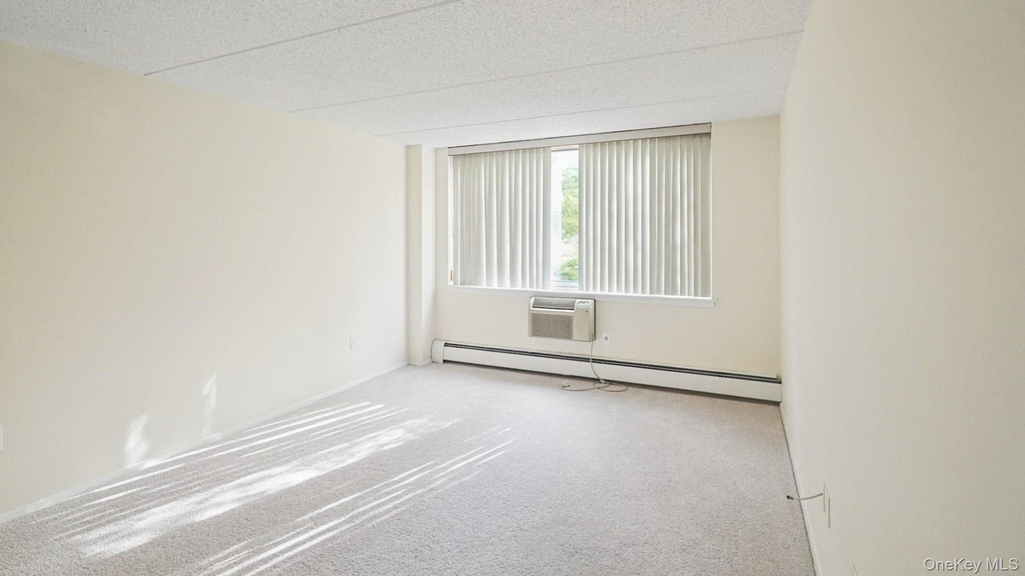 703 Pelham Road, Unit 107 New Rochelle, NY 10805 - Photo 9 of 14 a view of an empty room with a window