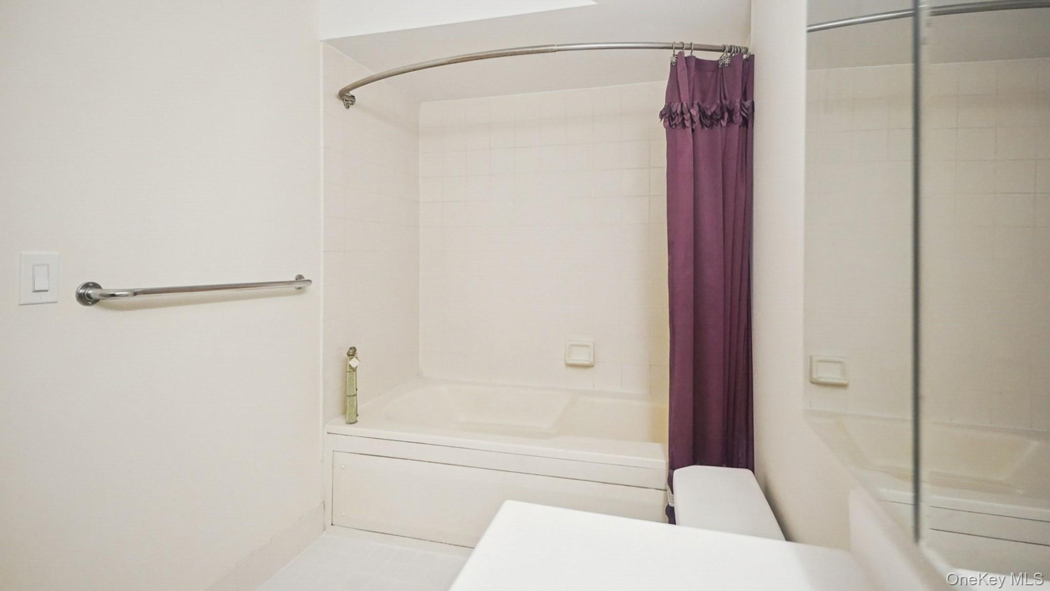 703 Pelham Road, Unit 107 New Rochelle, NY 10805 - Photo 10 of 14 a bathroom with a shower and a bath tub