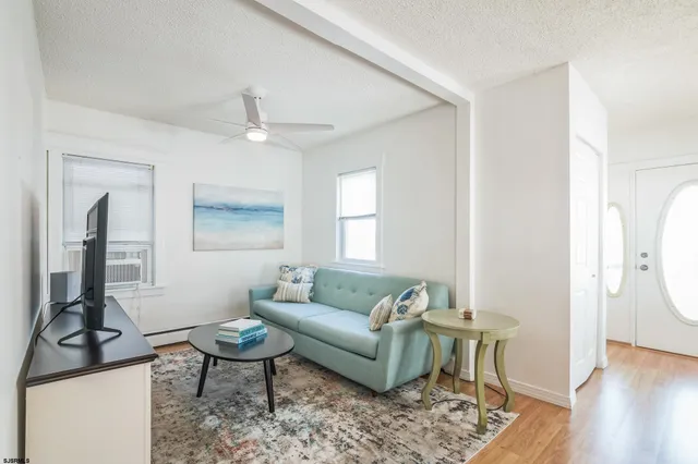 a living room with furniture a window and a table
